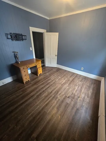 a view of a room with wooden floor