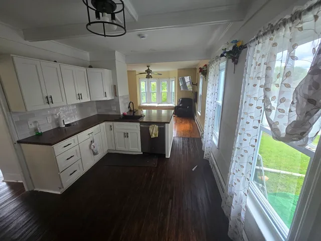 a kitchen with a sink a refrigerator and window
