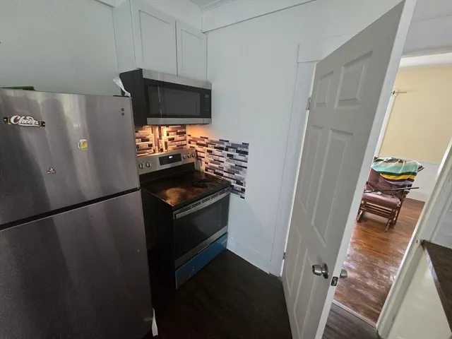 a view of washer and dryer with wooden floor