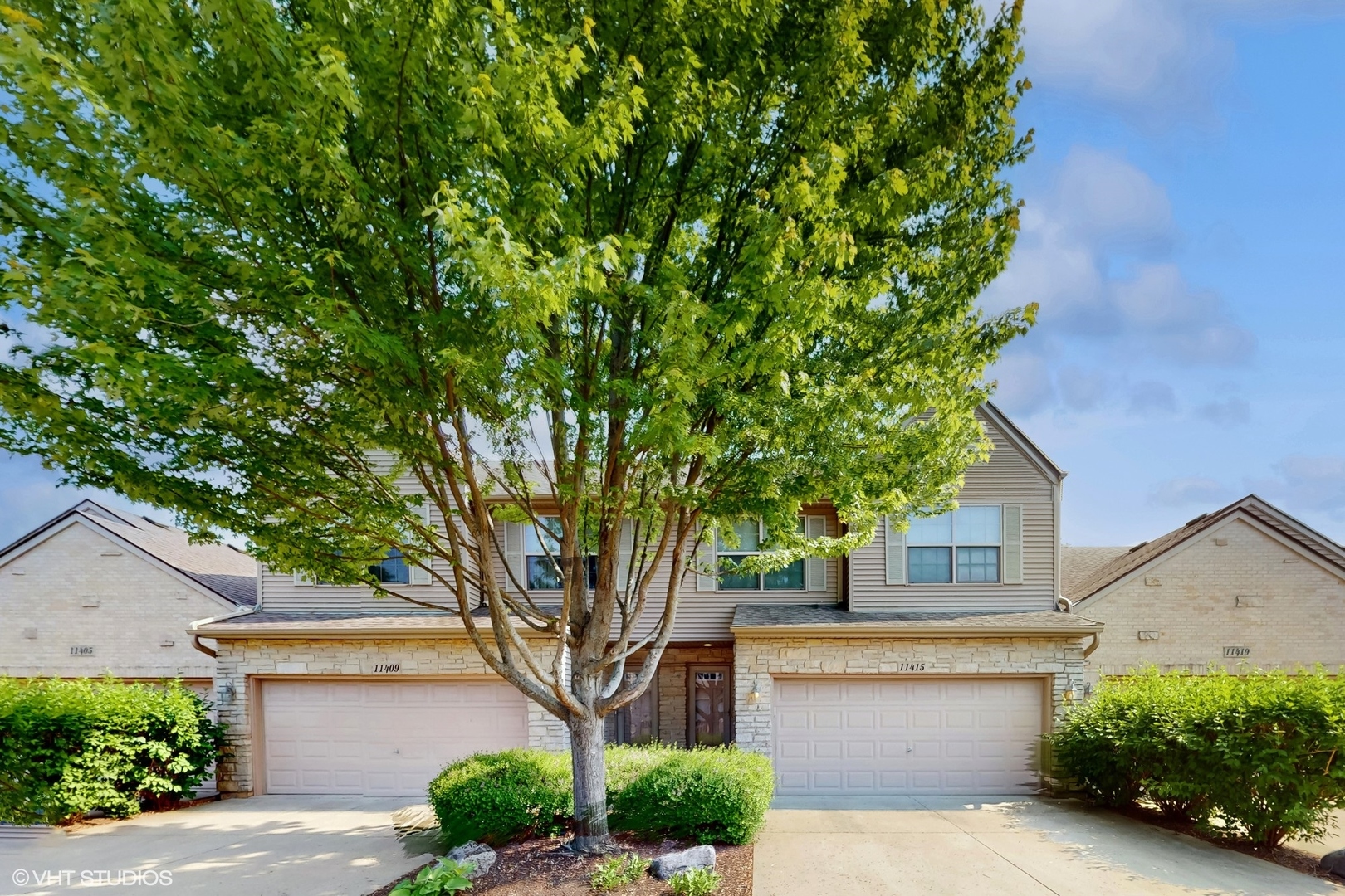 11415 Sisters Court, Unit 11415 Huntley, IL 60142 - Photo 2 of 32 a front view of a house with a garden