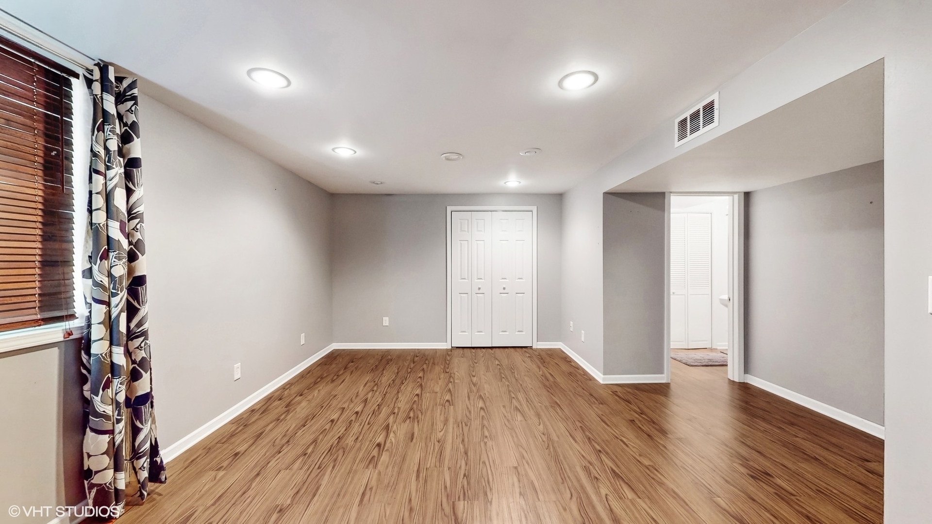 11415 Sisters Court, Unit 11415 Huntley, IL 60142 - Photo 23 of 32 a view of a room with wooden floor and windows