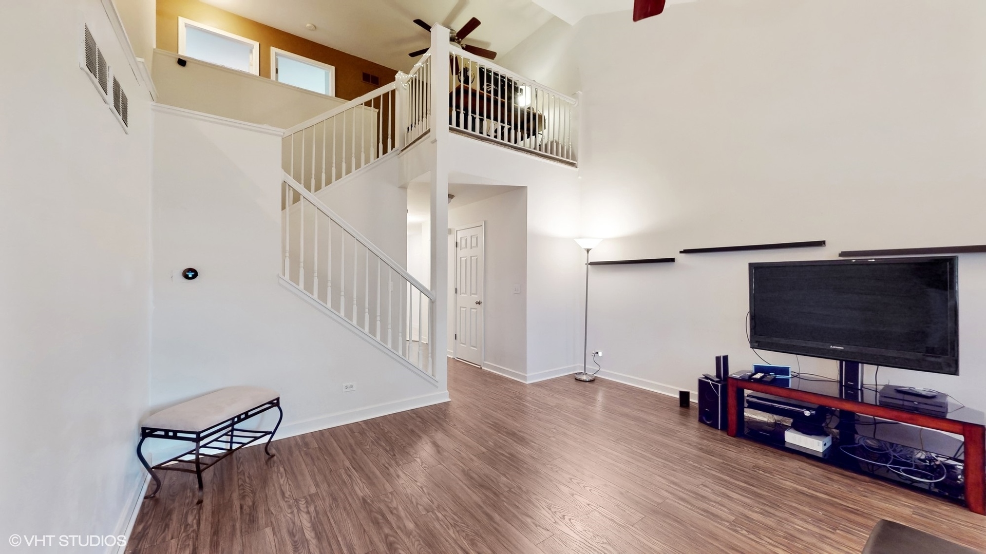 11415 Sisters Court, Unit 11415 Huntley, IL 60142 - Photo 5 of 32 a view of a livingroom with wooden floor and a flat screen tv