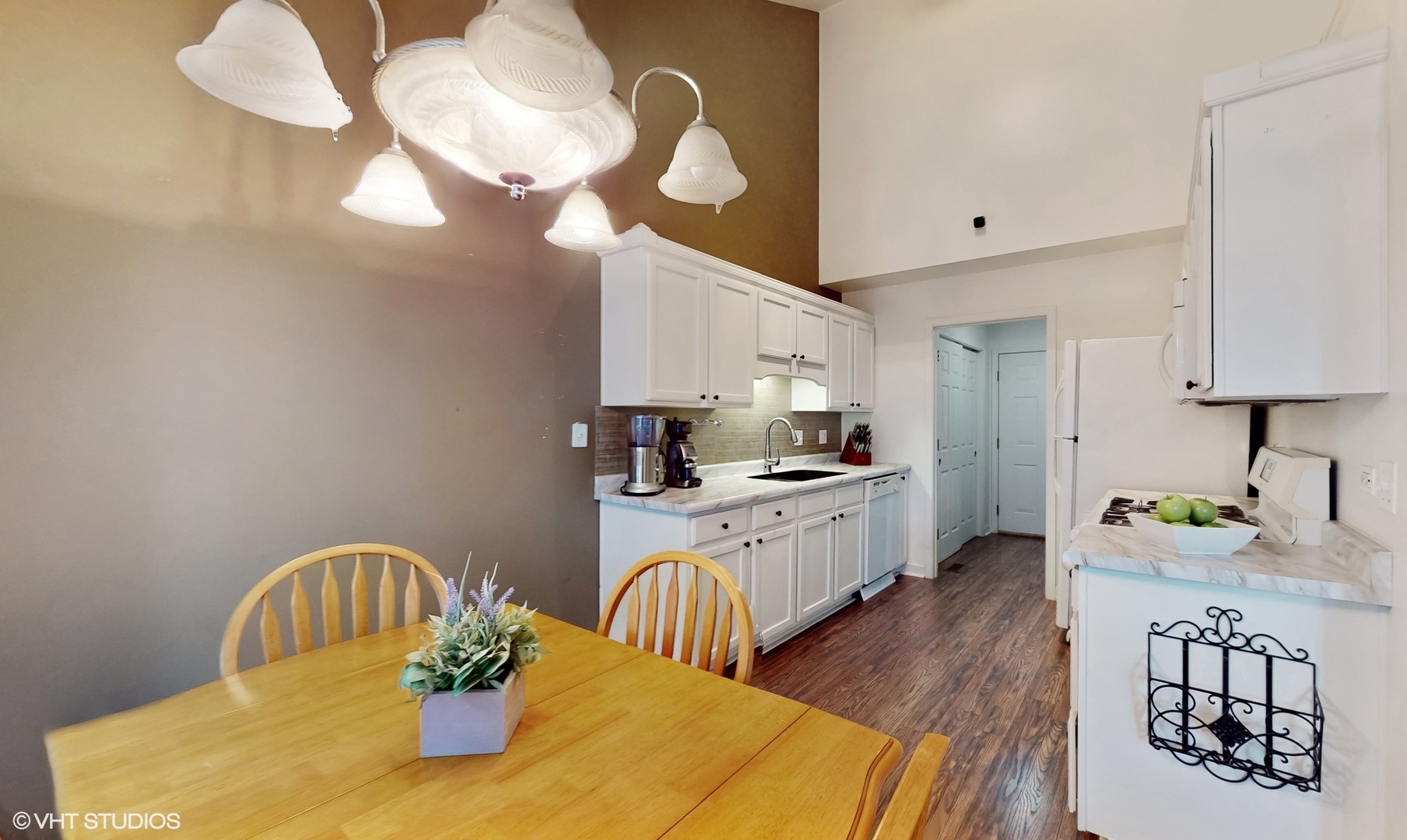 11415 Sisters Court, Unit 11415 Huntley, IL 60142 - Photo 10 of 32 a kitchen with sink refrigerator dining table and chairs
