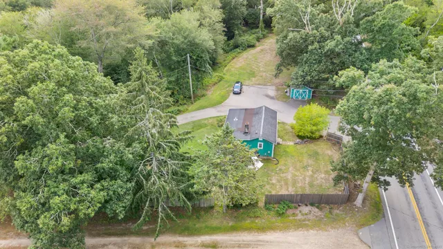 an aerial view of a house with a yard