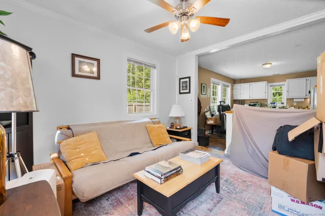 a living room with furniture and a chandelier
