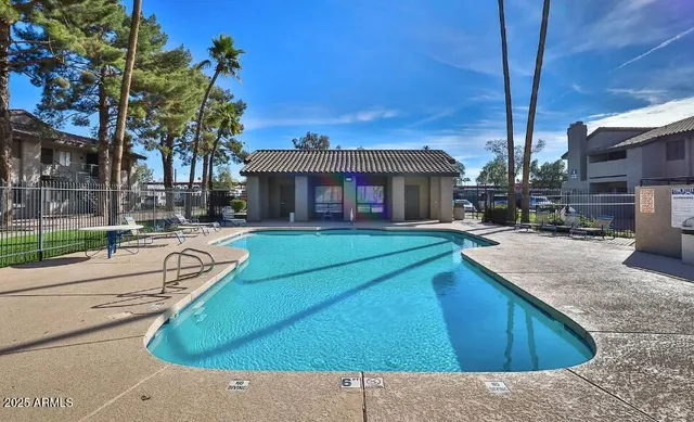 a view of a house with pool and sitting area