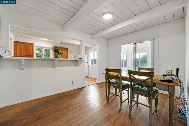 a dining room with furniture and wooden floor