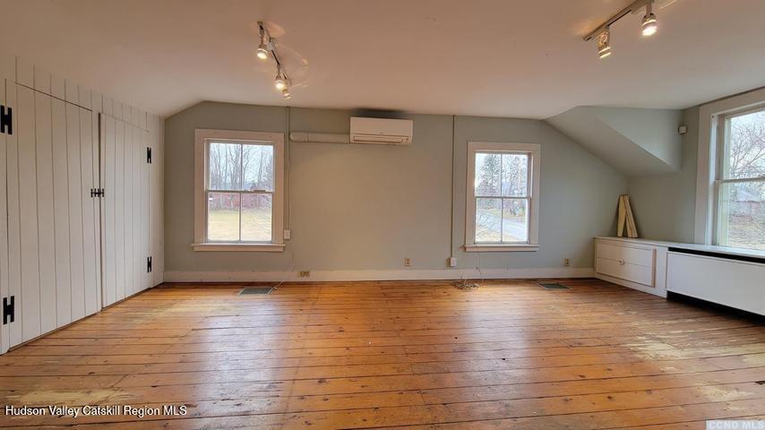 2948 County Rte 9 East Chatham, NY 12060 - Photo 14 of 32 an empty room with wooden floor and windows