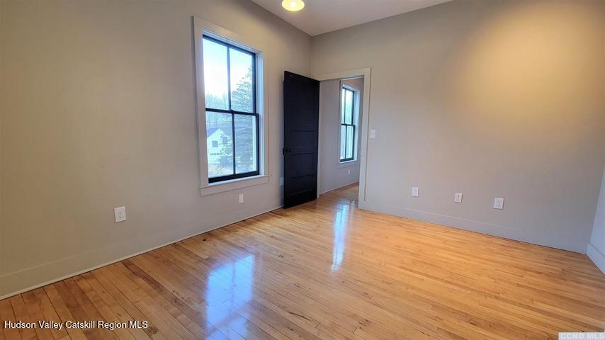 2948 County Rte 9 East Chatham, NY 12060 - Photo 17 of 32 a view of an empty room with wooden floor and window