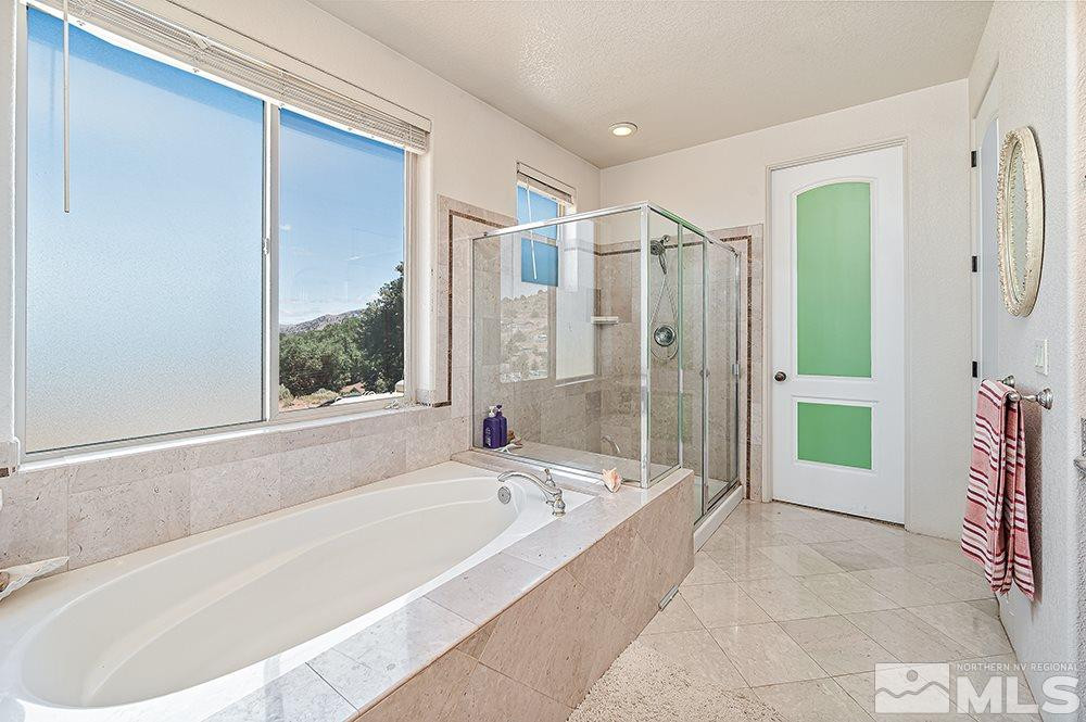15850 Rocky Vista Road Reno, NV 89521 - Photo 15 of 40 a spacious bathroom with a bathtub and shower
