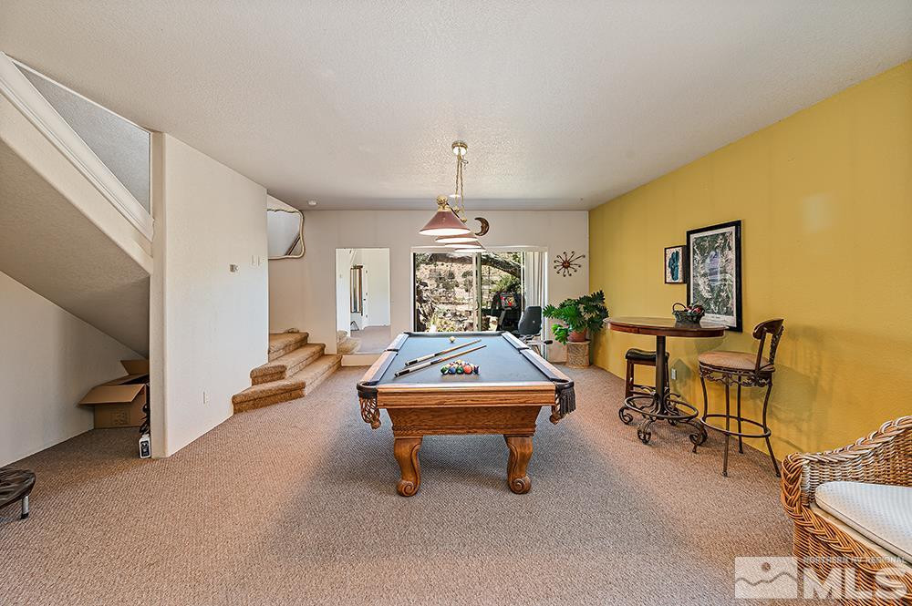 15850 Rocky Vista Road Reno, NV 89521 - Photo 22 of 40 a living room with furniture and a chandelier
