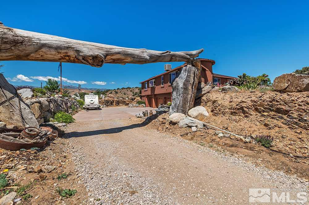 15850 Rocky Vista Road Reno, NV 89521 - Photo 28 of 40 a view of a backyard with table and chairs under an umbrella