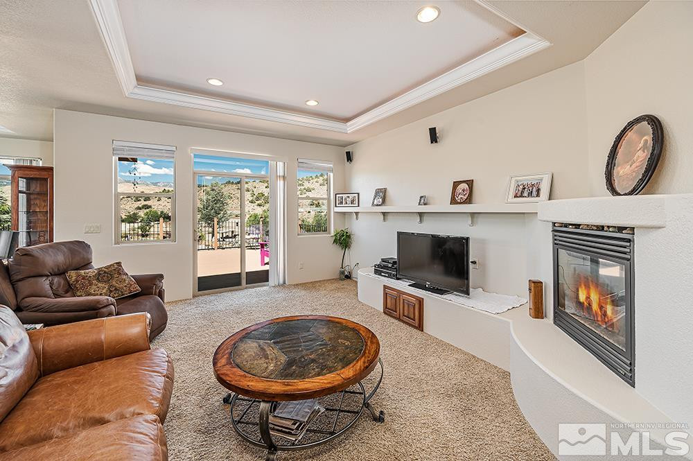 15850 Rocky Vista Road Reno, NV 89521 - Photo 5 of 40 a living room with furniture a flat screen tv and a fireplace