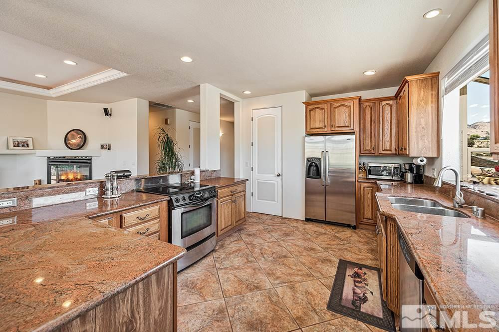 15850 Rocky Vista Road Reno, NV 89521 - Photo 8 of 40 a large kitchen with granite countertop a large counter top stainless steel appliances and cabinets