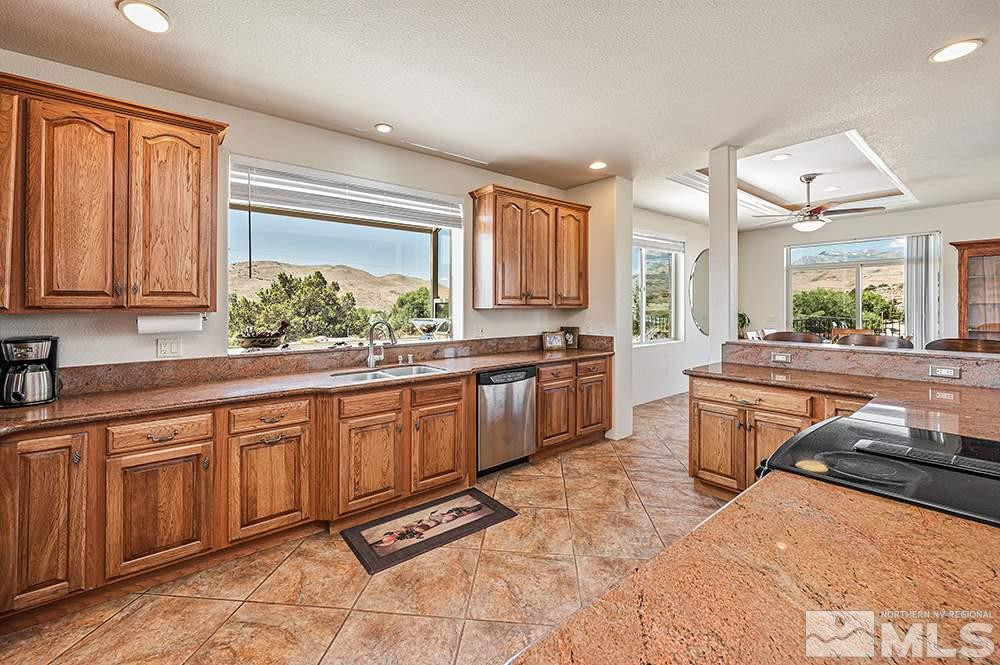 15850 Rocky Vista Road Reno, NV 89521 - Photo 9 of 40 a kitchen with stainless steel appliances granite countertop a stove a sink and a microwave