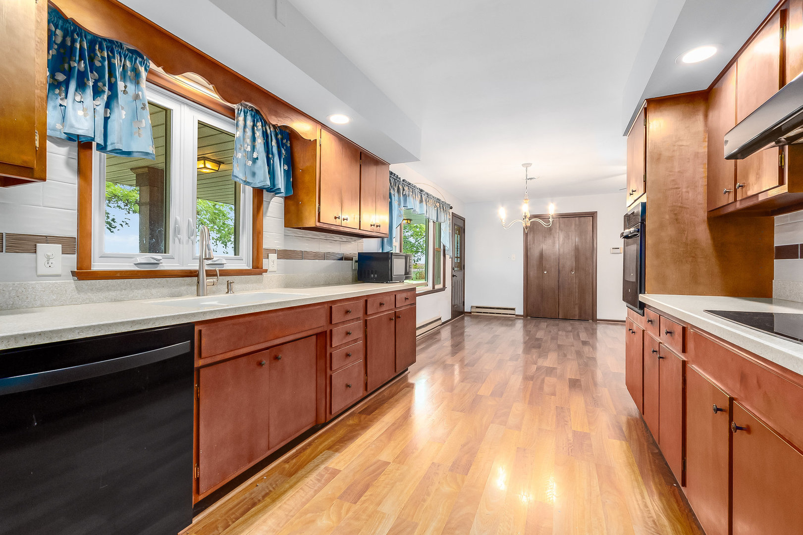 14255 Grove Road Minooka, IL 60447 - Photo 5 of 38 a large kitchen with stainless steel appliances granite countertop a large window a sink and a counter space