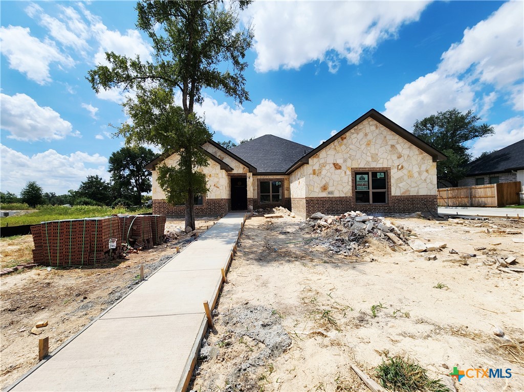 a view of a house with snow on the road