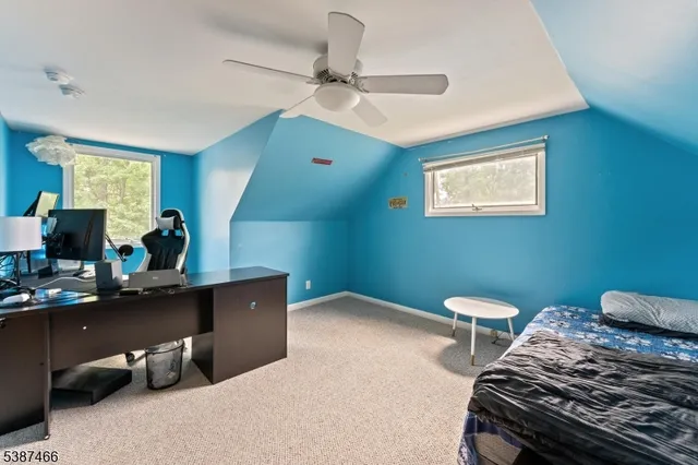 a bedroom with a bed and a desk