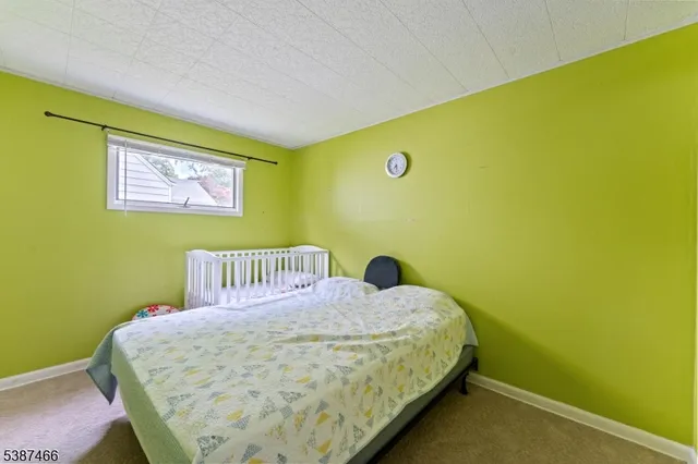 a bedroom with a bed and cupboard