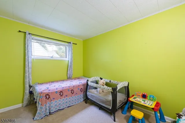 a bed room with a bed and a chair