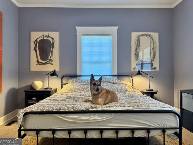 a bedroom with a large bed and a window