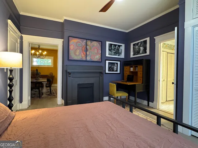 a living room with furniture windows and a potted plant