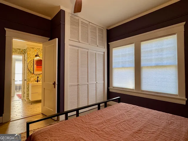 a dining room with furniture a flat screen tv and a floor to ceiling window