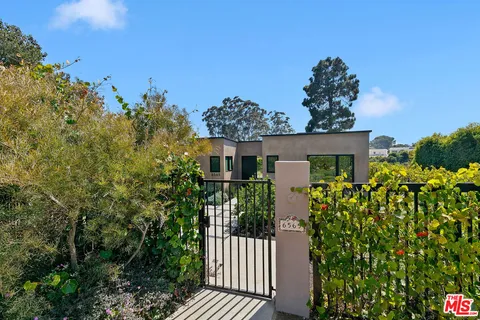 a view of a house with a flower garden