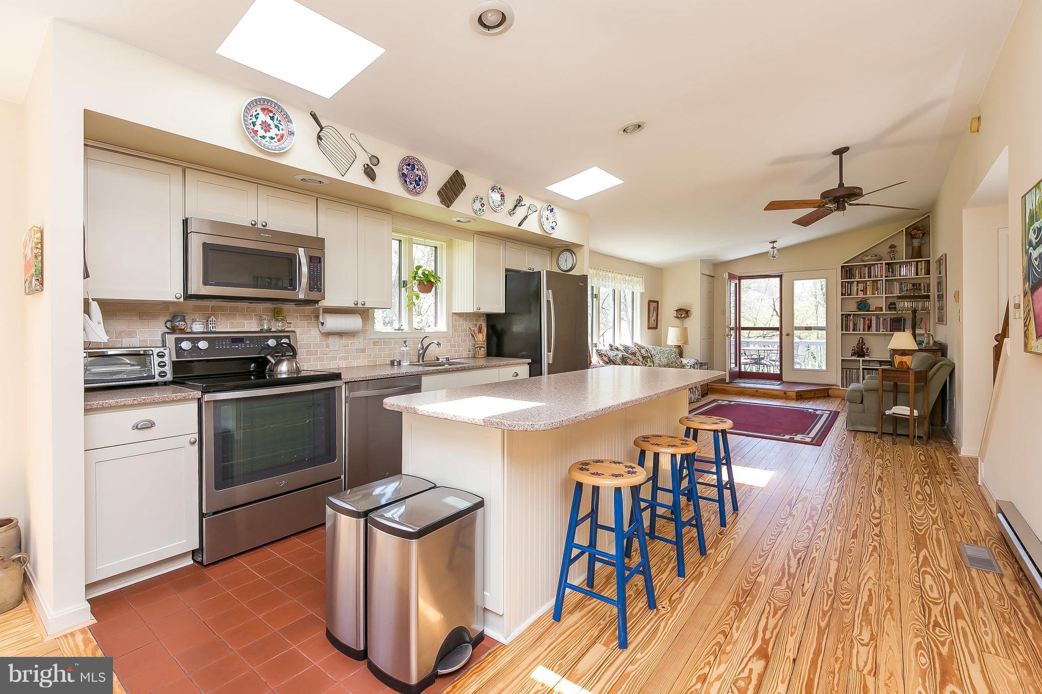 1801 Blue Mt Road Monkton, MD 21111 - Photo 5 of 30 a kitchen with stainless steel appliances kitchen island granite countertop a stove top oven a sink a dining table and chairs