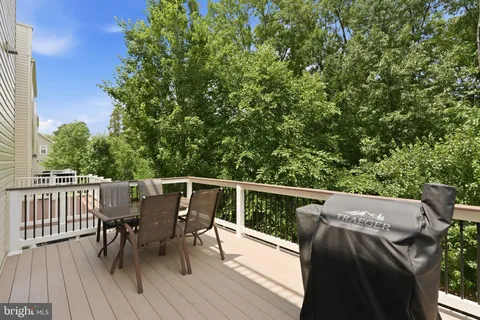 a view of balcony with furniture and wooden floor