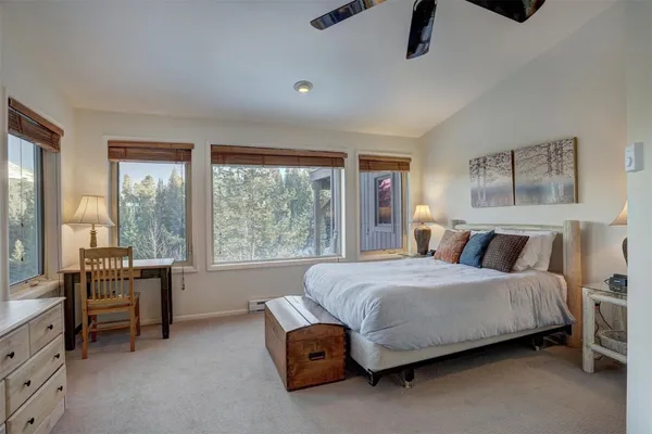 a living room with a bed furniture and a large window