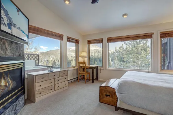 a room with a bed and a view of living room