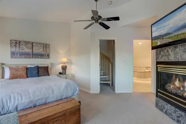 a bedroom with a bed and a fireplace