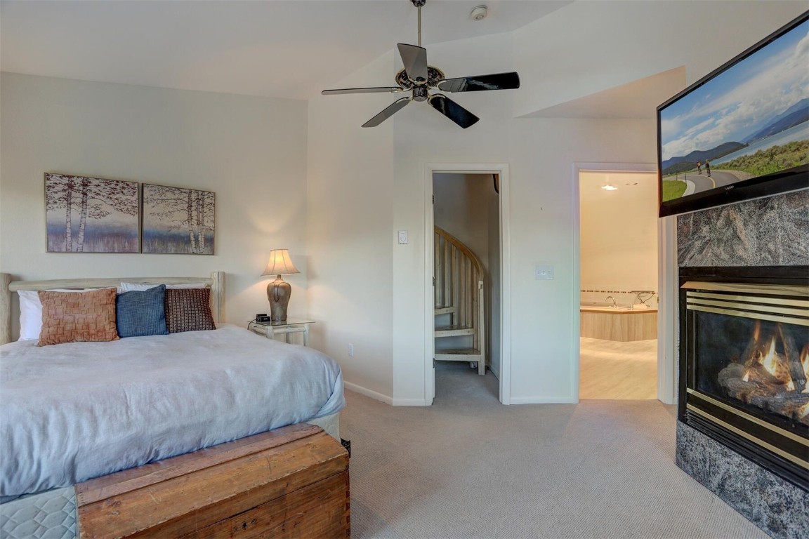 965 4 O Clock Road Breckenridge, CO 80424 - Photo 17 of 32 a bedroom with a bed and a fireplace