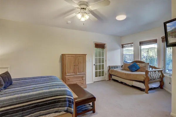 a bedroom with a bed and a chandelier