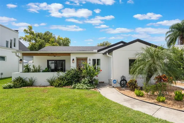 a front view of house with yard and green space