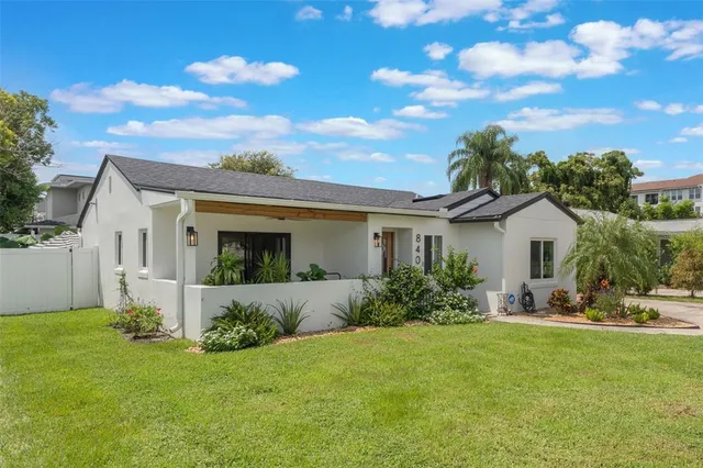 a front view of house with yard and green space