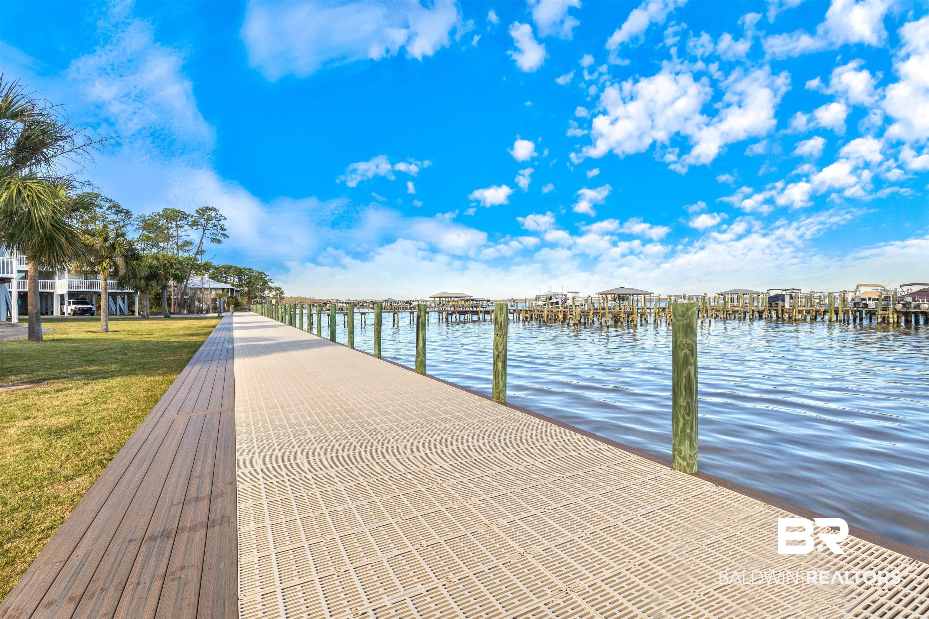 25861 Canal Road, Unit 3 Orange Beach, AL 36561 - Photo 27 of 40 Dock area featuring a water view and a lawn