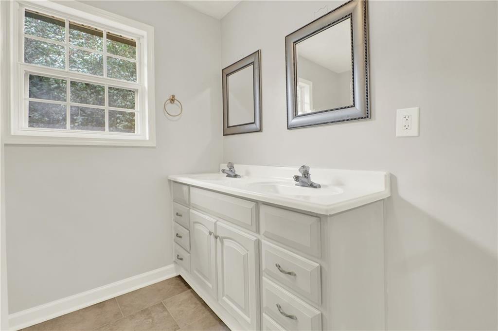 76 Picklesimer Road Southwest Cartersville, GA 30120 - Photo 19 of 43 a bathroom with a sink and a mirror