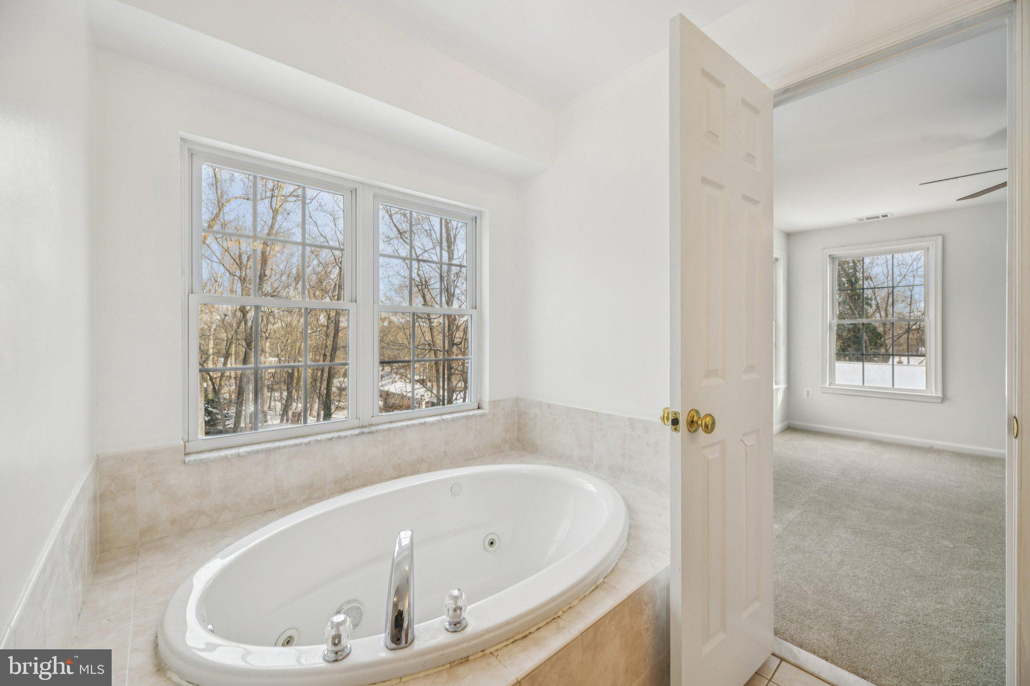 205 Captain Brendt Drive Accokeek, MD 20607 - Photo 14 of 37 a white bath tub sitting in a bathroom next to a window
