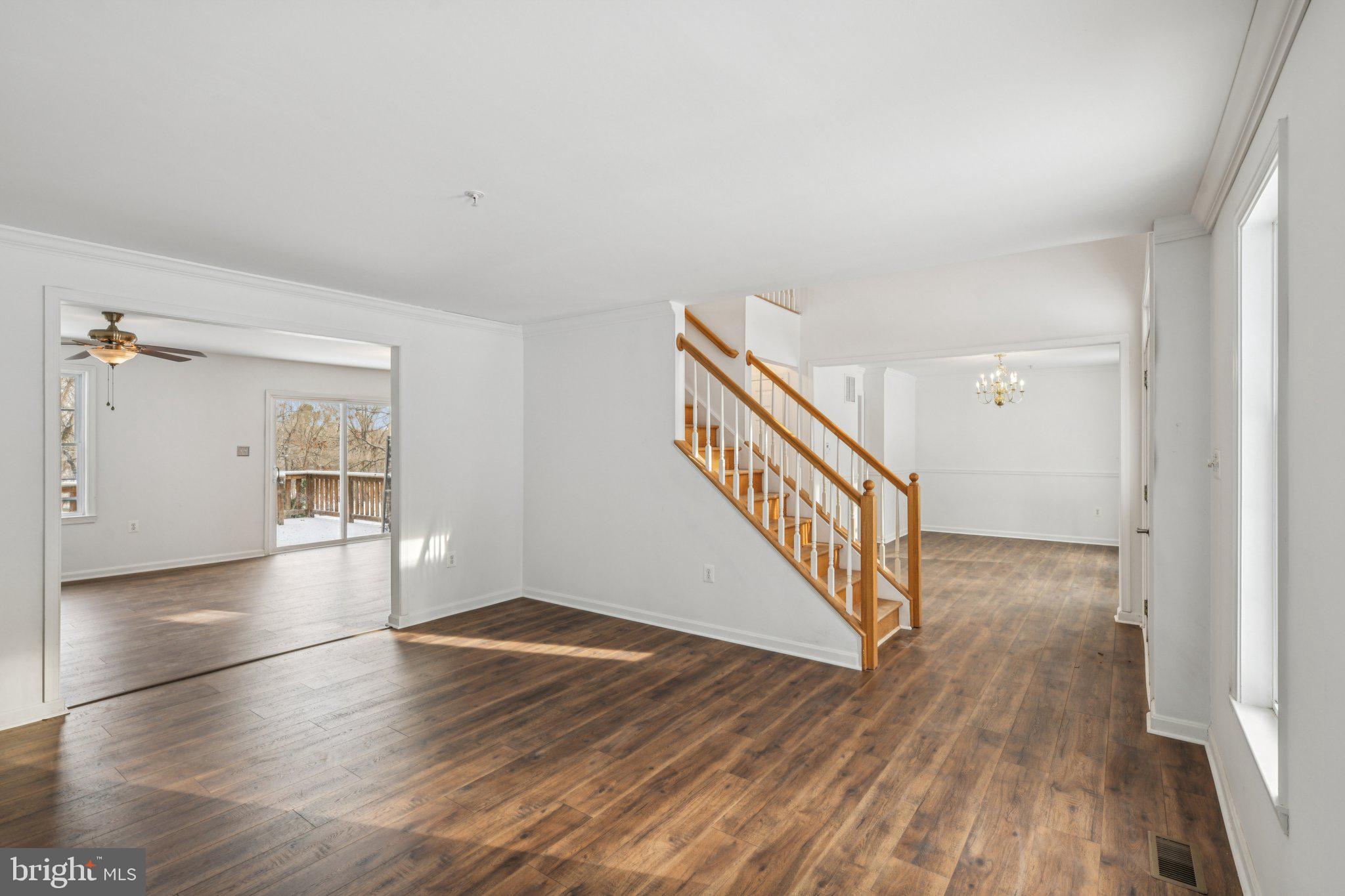 205 Captain Brendt Drive Accokeek, MD 20607 - Photo 3 of 37 a view of a hallway with wooden floor and staircase