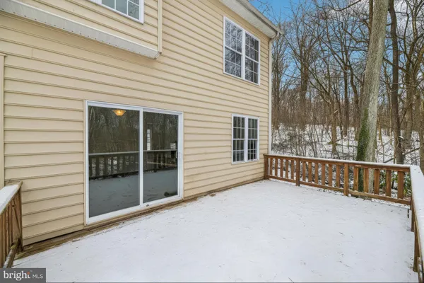 a view of a porch with wooden floor and fence and a floor to ceiling window