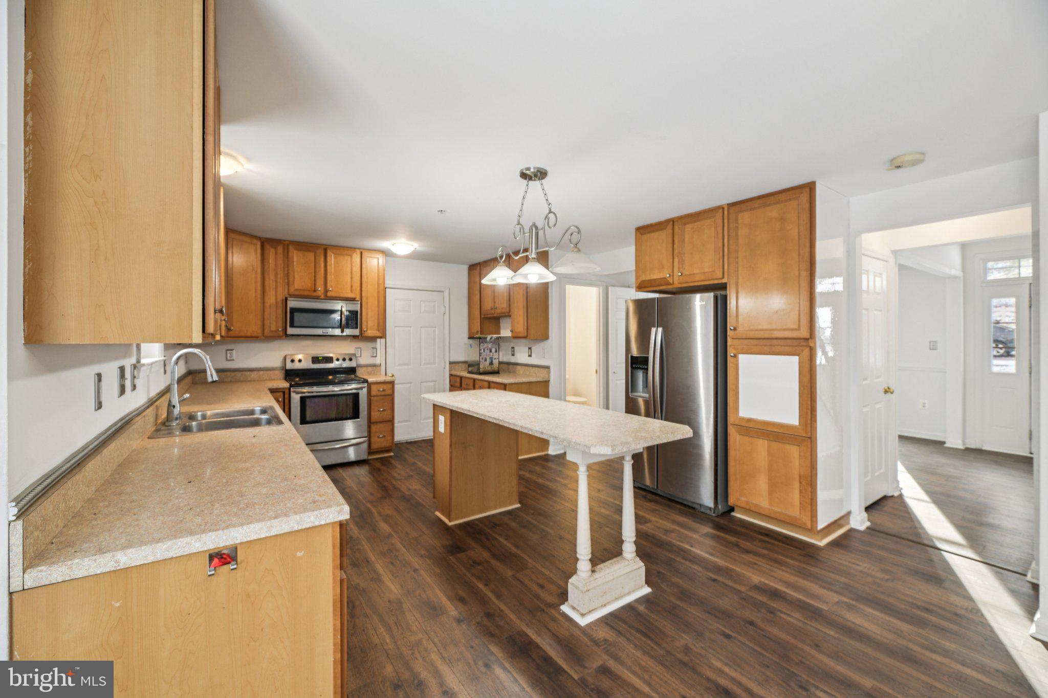 205 Captain Brendt Drive Accokeek, MD 20607 - Photo 7 of 37 a kitchen with a refrigerator a sink and wooden floor