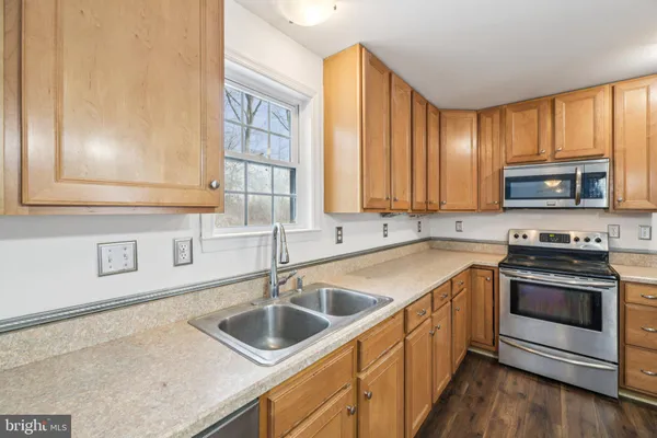 a kitchen that has a sink and a stove