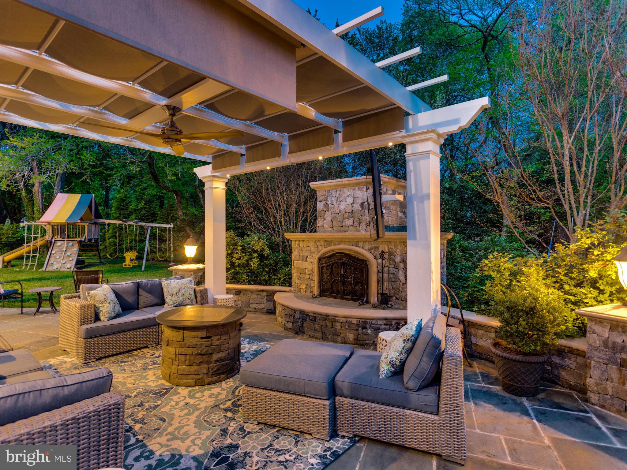 8537 Riverside Road Alexandria, VA 22308 - Photo 4 of 30 a outdoor living space with furniture potted plant and a fireplace