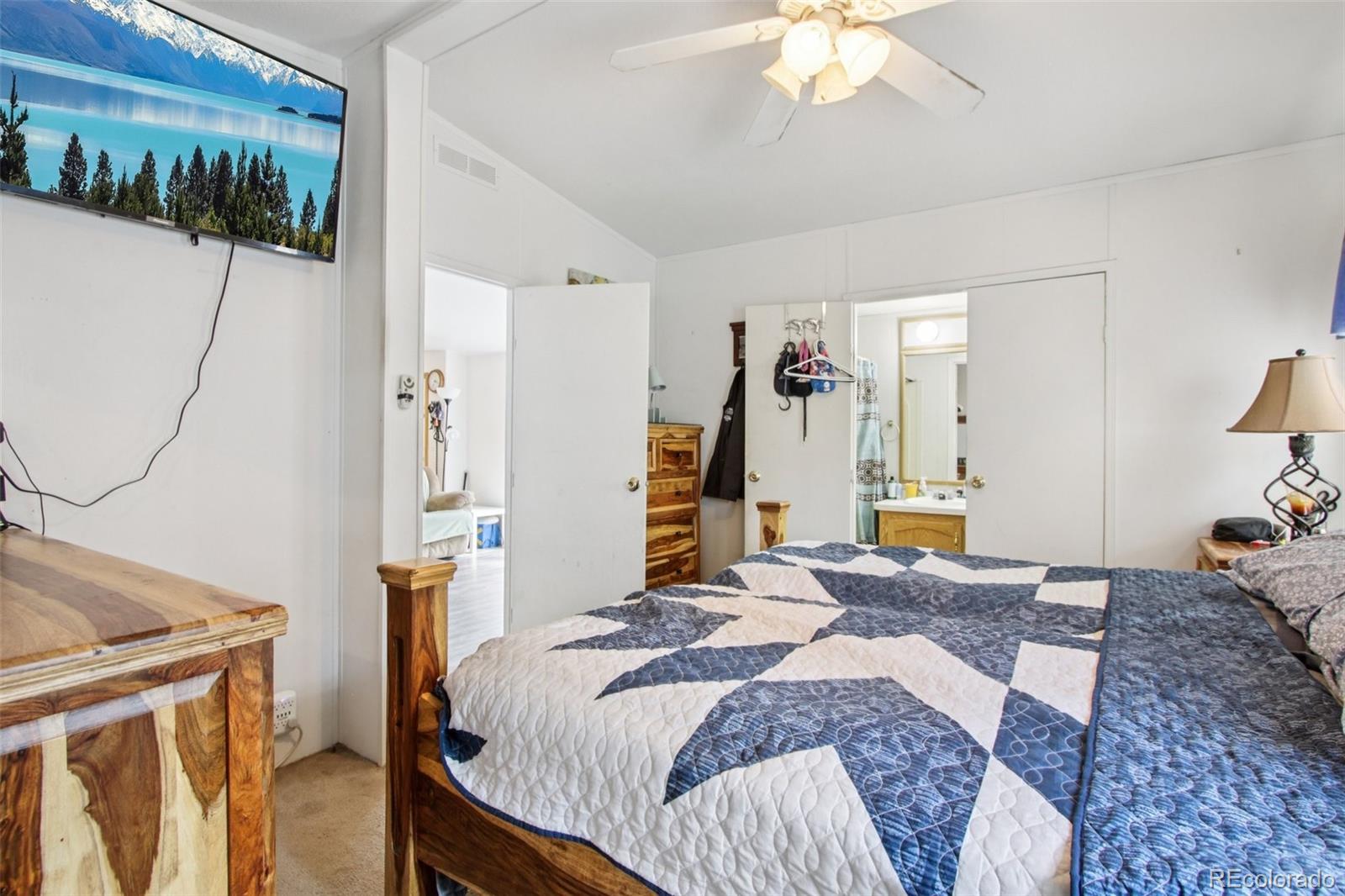81 Atlantis Road Black Hawk, CO 80422 - Photo 17 of 40 a bed room with a bed and a chandelier