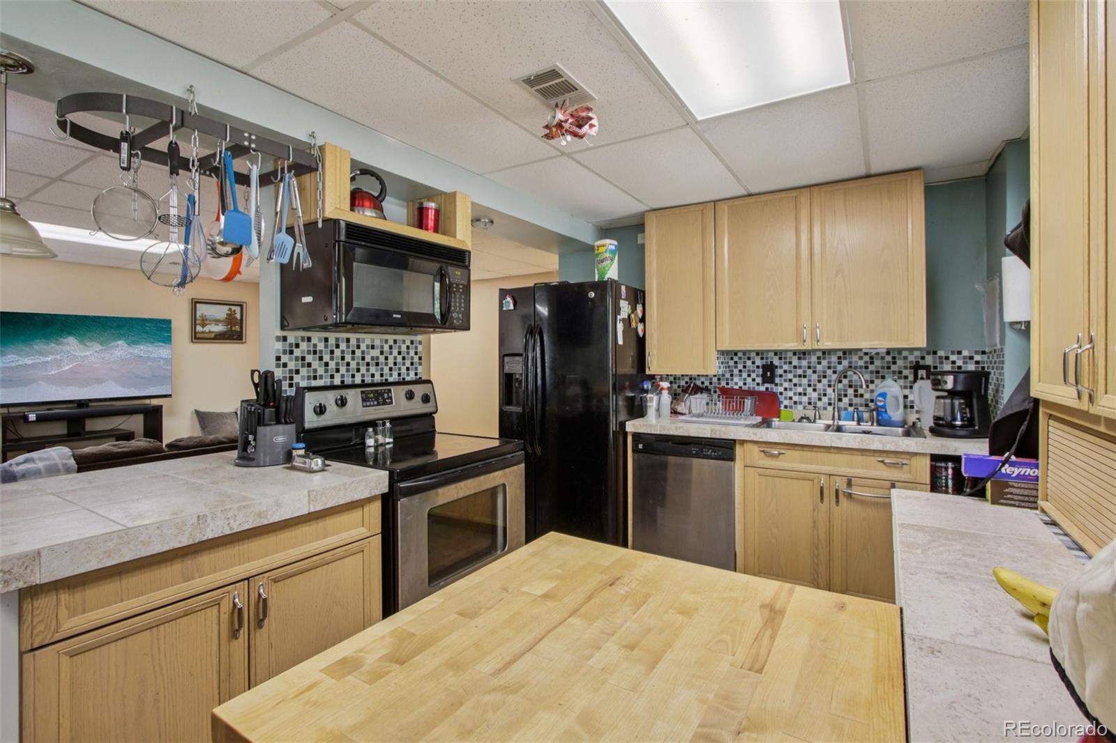 81 Atlantis Road Black Hawk, CO 80422 - Photo 22 of 40 a kitchen with stainless steel appliances kitchen island granite countertop a refrigerator stove top oven and sink