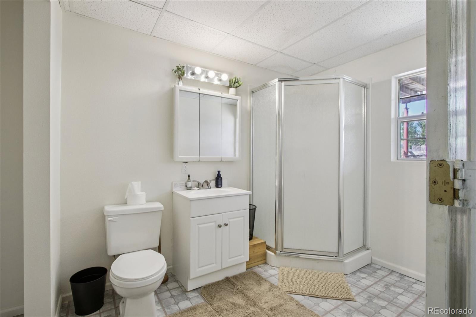 81 Atlantis Road Black Hawk, CO 80422 - Photo 27 of 40 a bathroom with a toilet a sink and shower