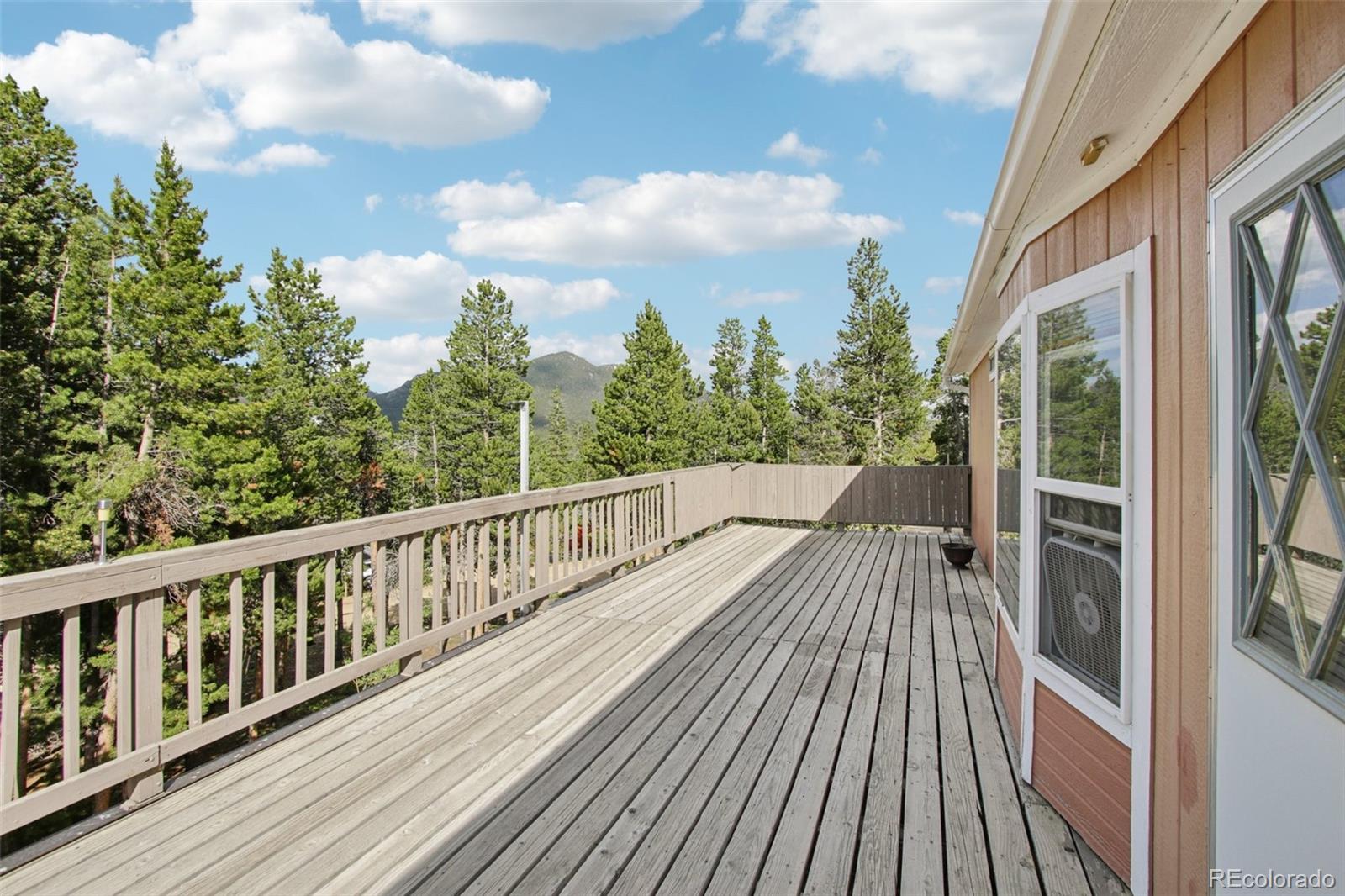 81 Atlantis Road Black Hawk, CO 80422 - Photo 3 of 40 a view of balcony with wooden floor and fence