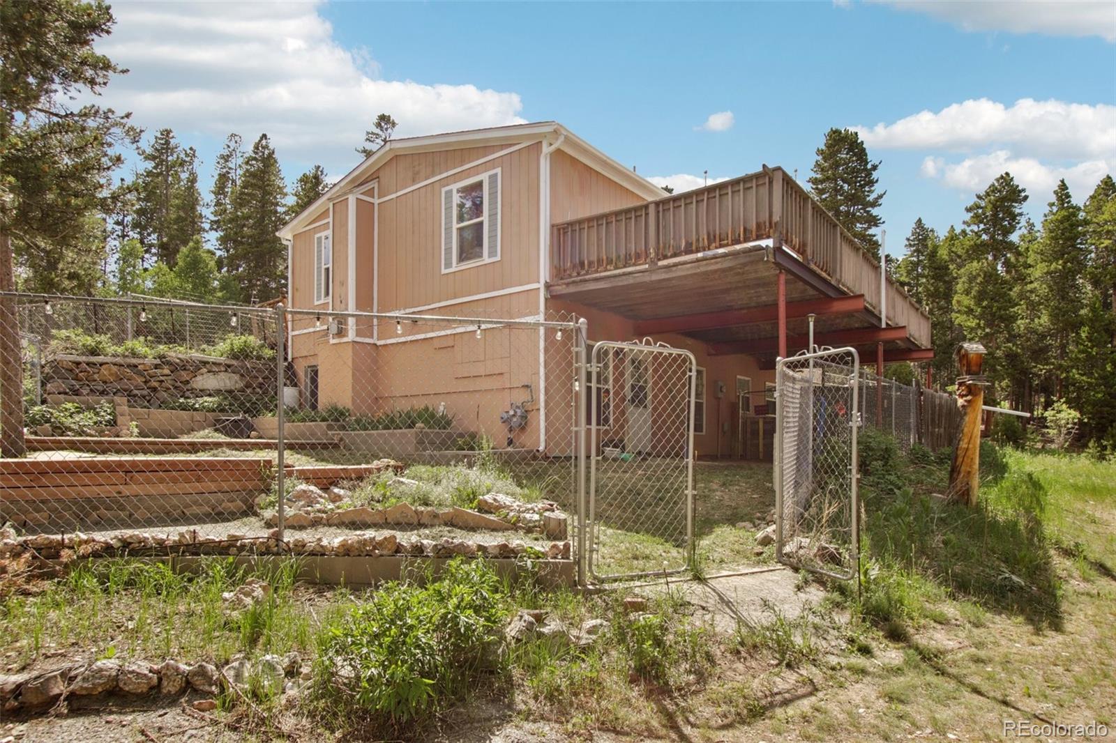 81 Atlantis Road Black Hawk, CO 80422 - Photo 40 of 40 a backyard of a house with a yard and outdoor seating